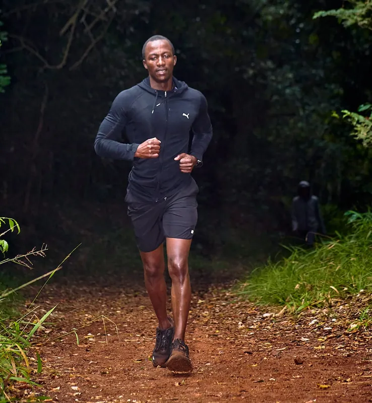 A runner on a forest trail during an outdoor fitness event